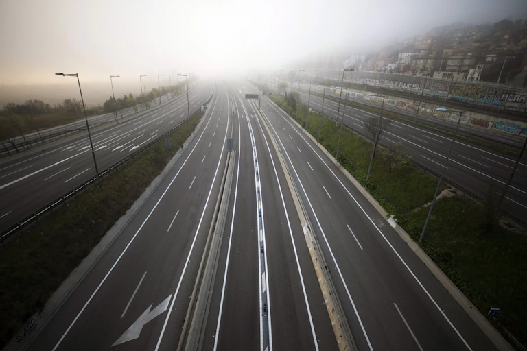 the highway leading to Barcelona is seen empty of cars