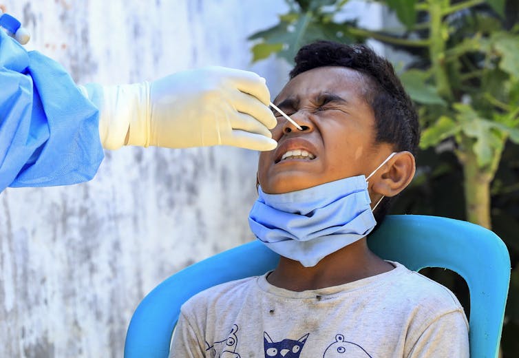 A boy undergoes a COVID test