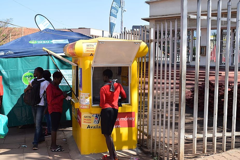 Customers at a mobile money kiosk