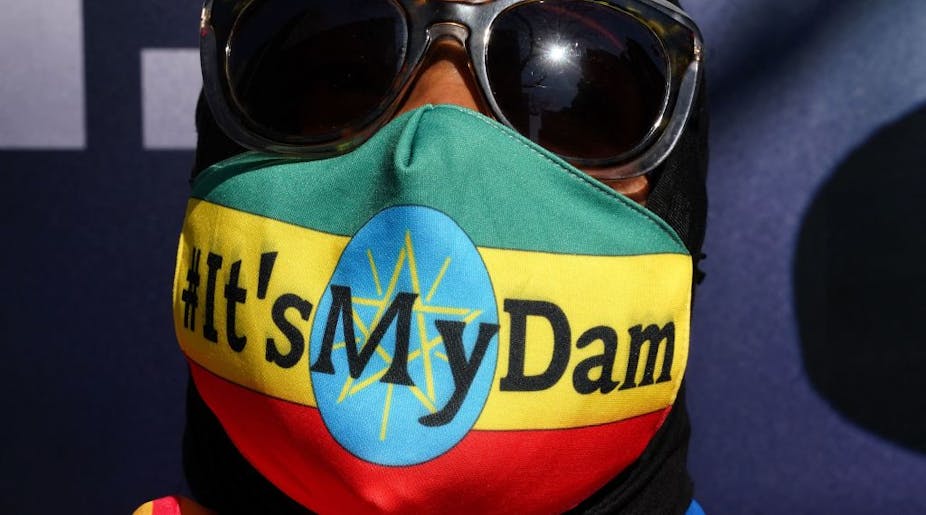 Ethiopian protestor wears a mask saying "it's my dam"