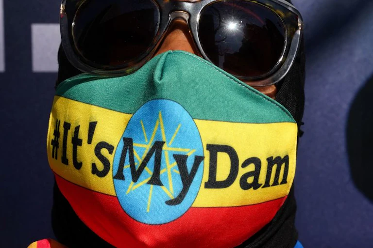 Ethiopian protestor wears a mask saying "it's my dam"