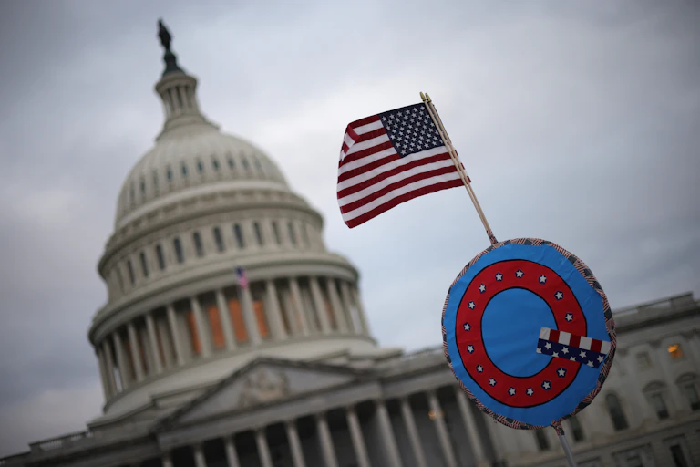 A U.S. flag adorned with a QAnon symbol flies near the U.S. Capitol.