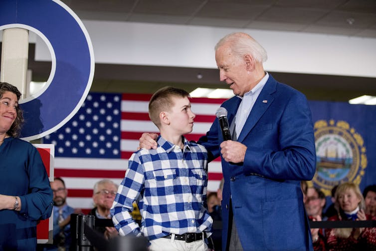 Joe Biden with a boy in a checked shirt.