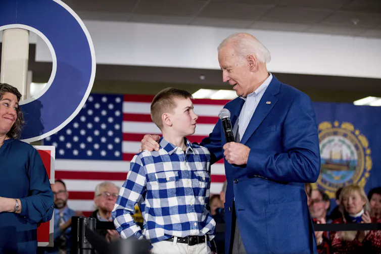 Joe Biden with a boy in a checked shirt.