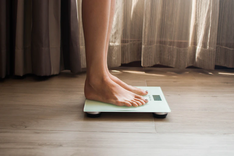 A person standing on a scale.