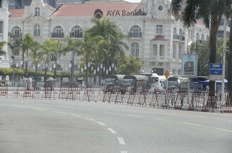 Police trucks block the road in front of City Hall in Yangon, Myanmar, April 13 2021.