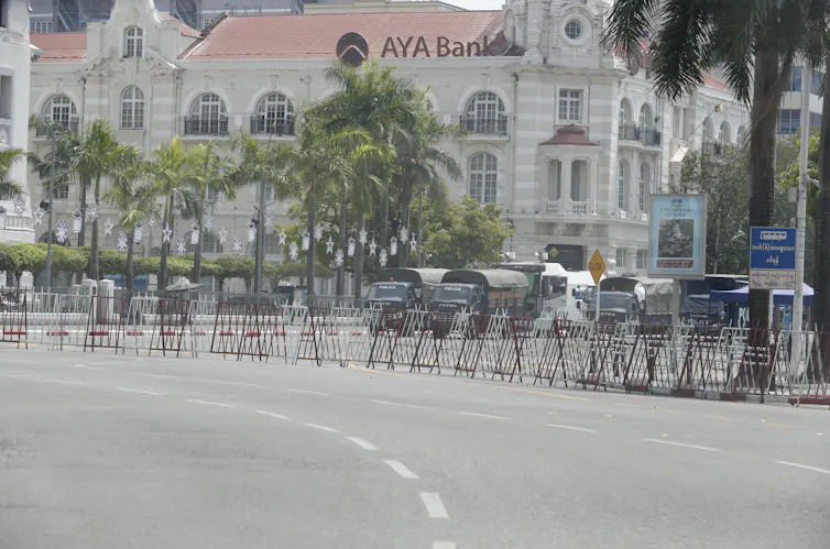 Police trucks block the road in front of City Hall in Yangon, Myanmar, April 13 2021.