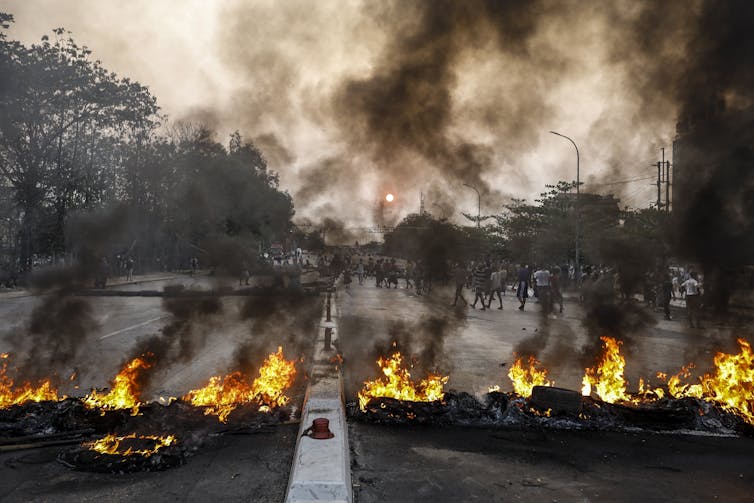 Burning tyres block a main road in Yangon, Myanmar, March 2021.
