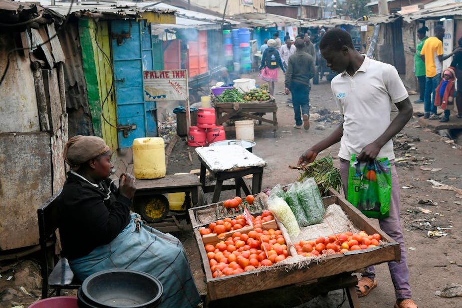 A man shops for vegetables in a low income settlement in Nairobi.