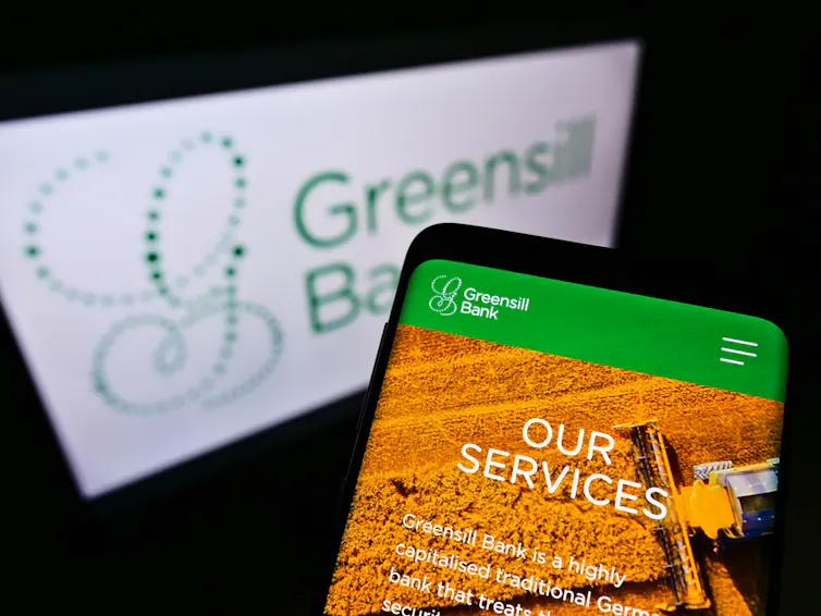 Phone showing Greensill app with company logo in background