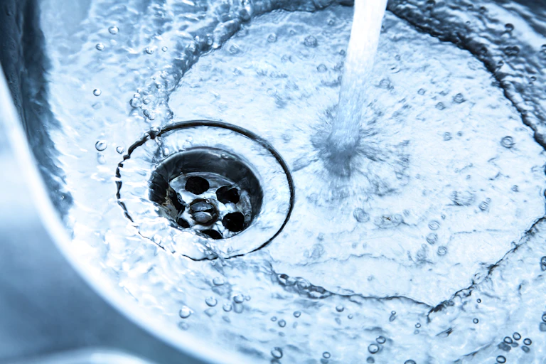 Water runs down a drain