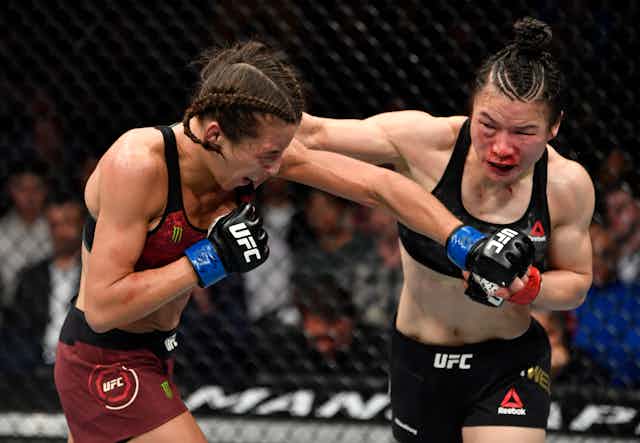 One woman punches another.