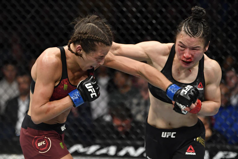 One woman punches another.