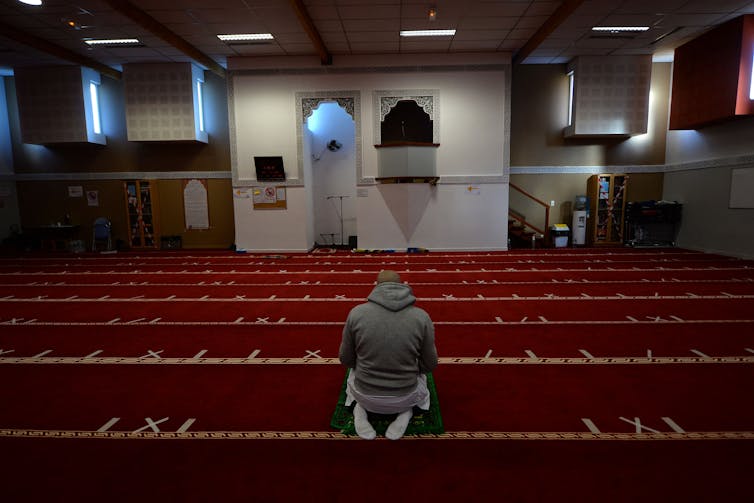 A man prays inside the Avicenna Islamic Cultural centre in Rennes