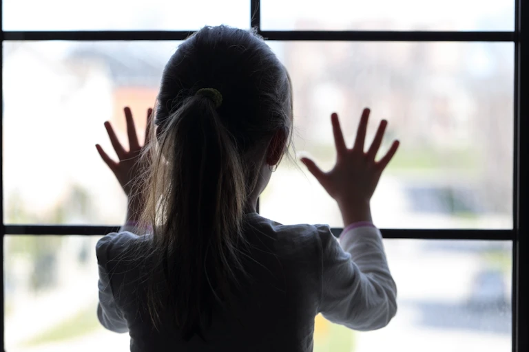 child looking out a window