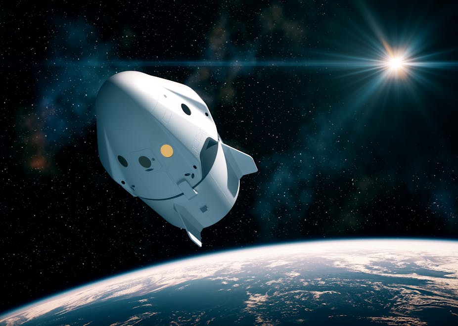 An artistic rendering of the Crew Dragon capsule floating through space above Earth.