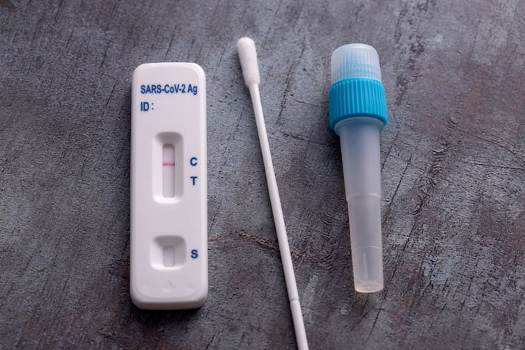A test device, cotton swab and sample tube.
