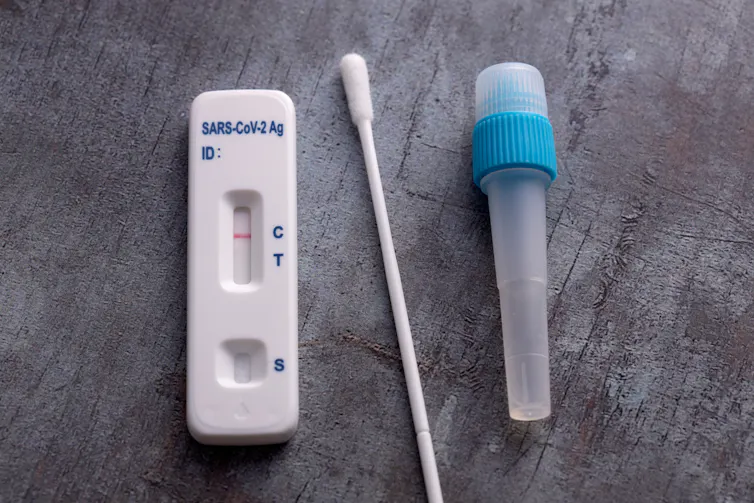 A test device, cotton swab and sample tube.