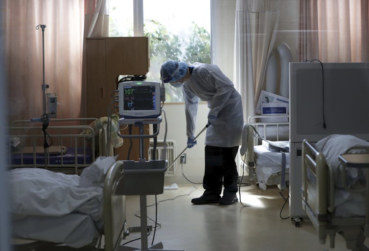 Hospital worker mops floor