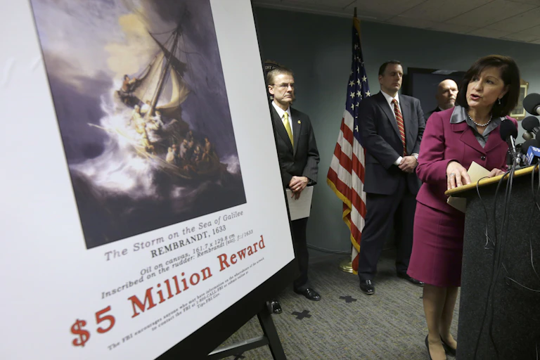FBI agents with reward poster for missing art.
