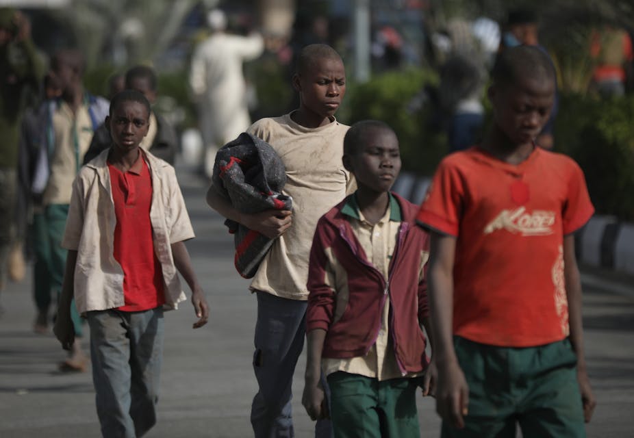 A group of boys walking along a road in Nigeria. 