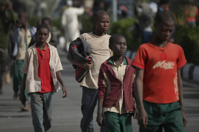 A group of boys walking along a road in Nigeria.