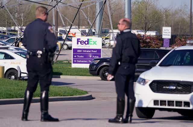 Two police officers in the FedEx parking area in Indianapolis.