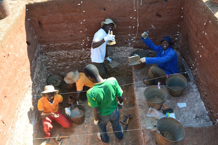 people excavate stone tools below the ground's surface