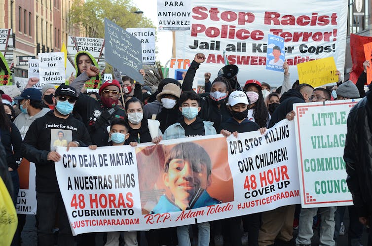 Protesters hold a banner saying 