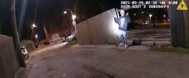 Bodycam footage shows 13-year-old Adam Toledo with his arms raised.
