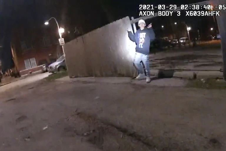 Bodycam footage shows 13-year-old Adam Toledo with his arms raised.