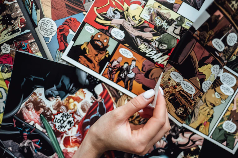 Hand flipping through comic book pages.
