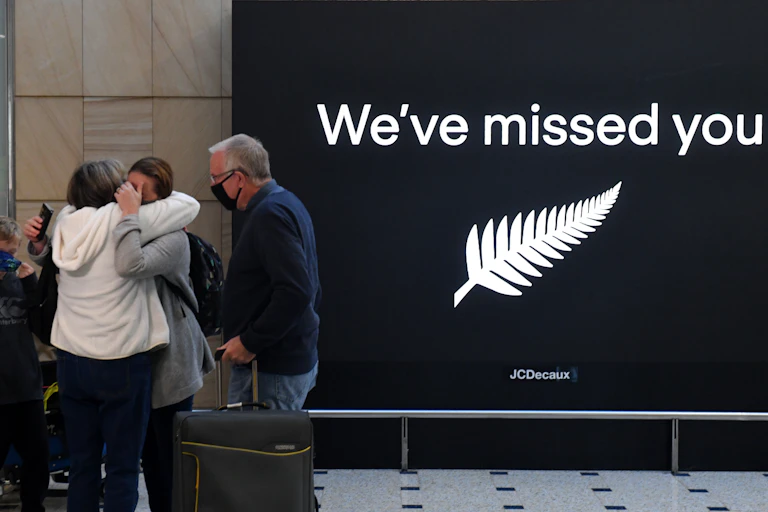 People hug at Sydney Airport
