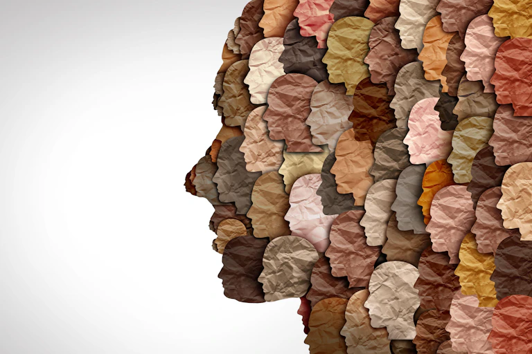 Collage in the shape of a face made up of smaller multicoloured faces