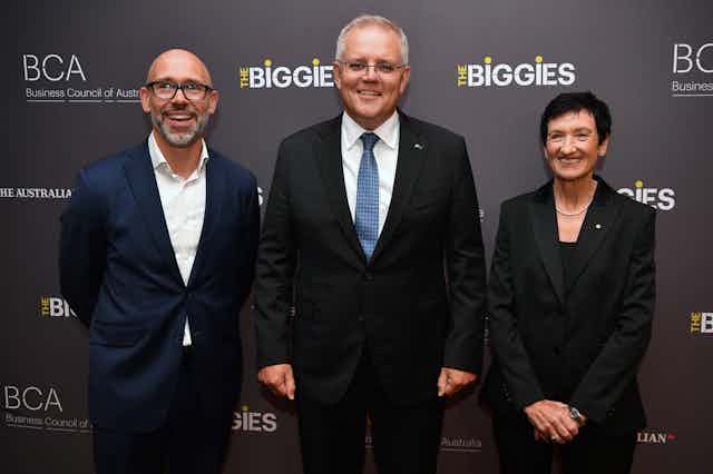 Prime Minister Scott Morrison (centre) poses for a photo with President of the Business Council Tim Reed (left) and CEO of the Business Council of Australia Jennifer Westacott (right)