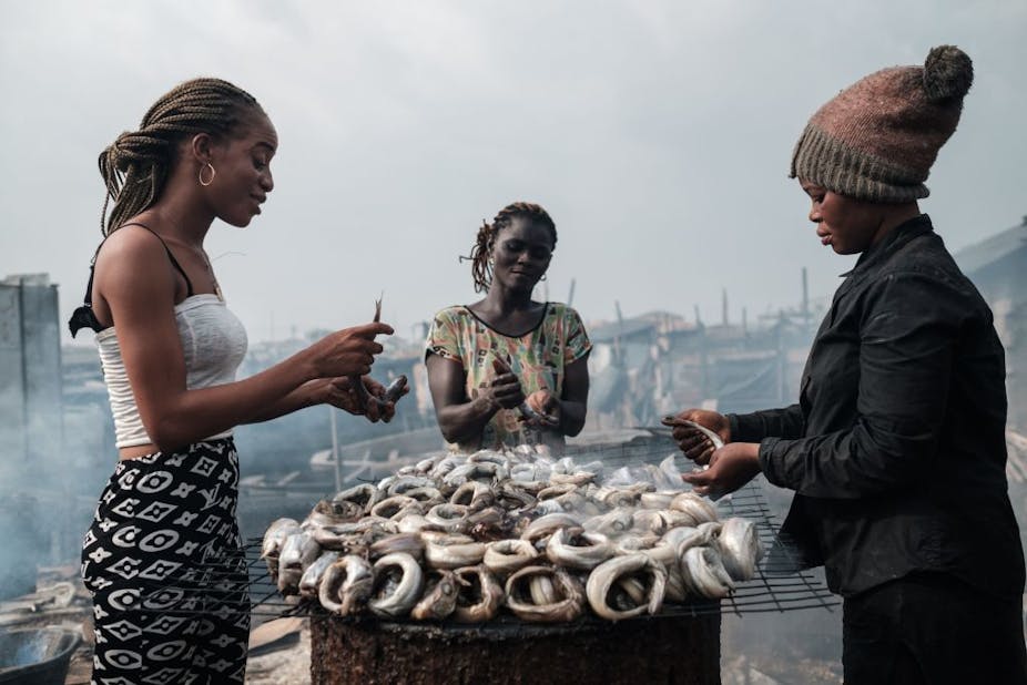 A group of women smoke fish