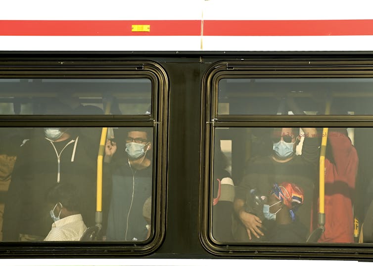 People wearing masks on a city busy