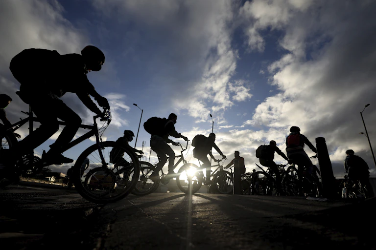 Silhouettes of people riding bikes.
