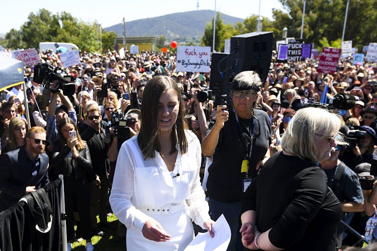 Higgins in white against a sea of black.