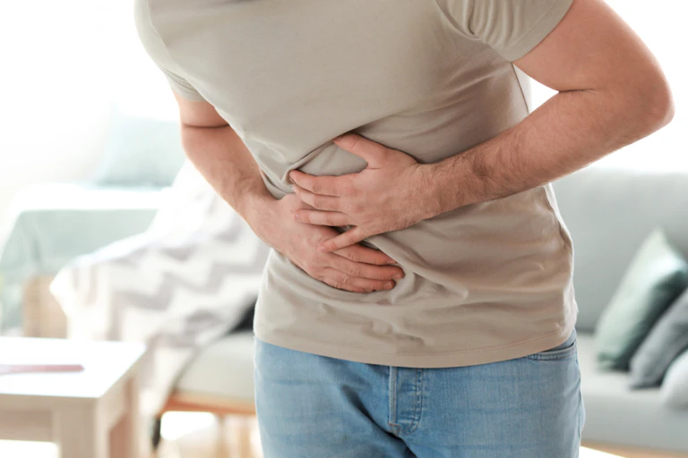 Man holding stomach