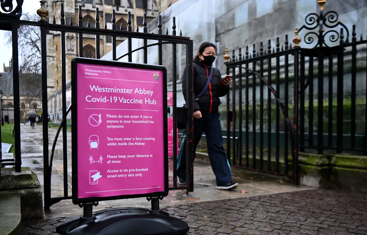 A woman leaving a vaccination centre in Westminster, London