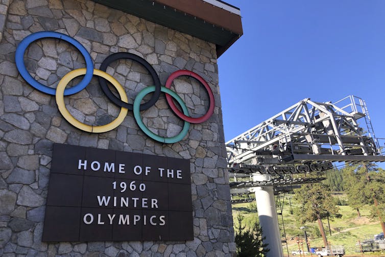 A 1960 Winter Olympics sign hangs on a ski resort in California that is named using a derogatory term for Native women