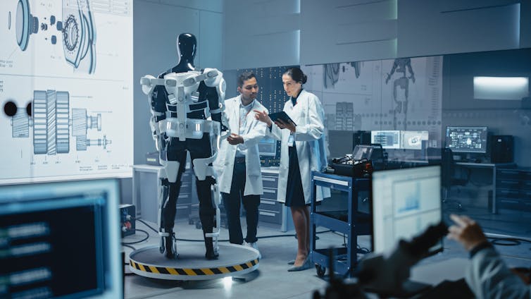 man and woman working in robotics laboratory