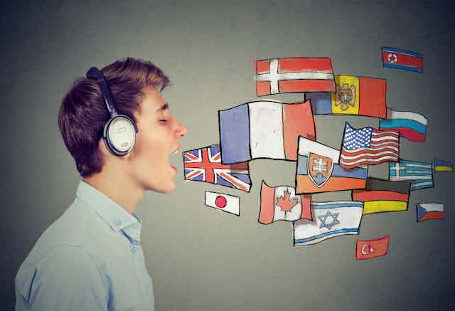 Young man speaks with eyes closed and headphones on, as cartoon flags come out of his mouth.