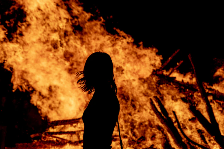 Woman's silhouette in front of fire