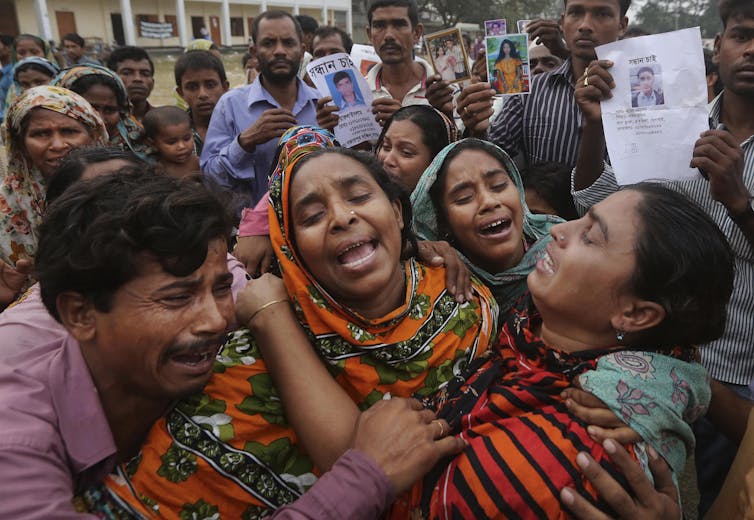 Relatives arrive to collect the body of garment worker Mohammed Abdullah on April 27 2013 at the makeshift morgue set in a schoolyard near the Rana Plaza site.