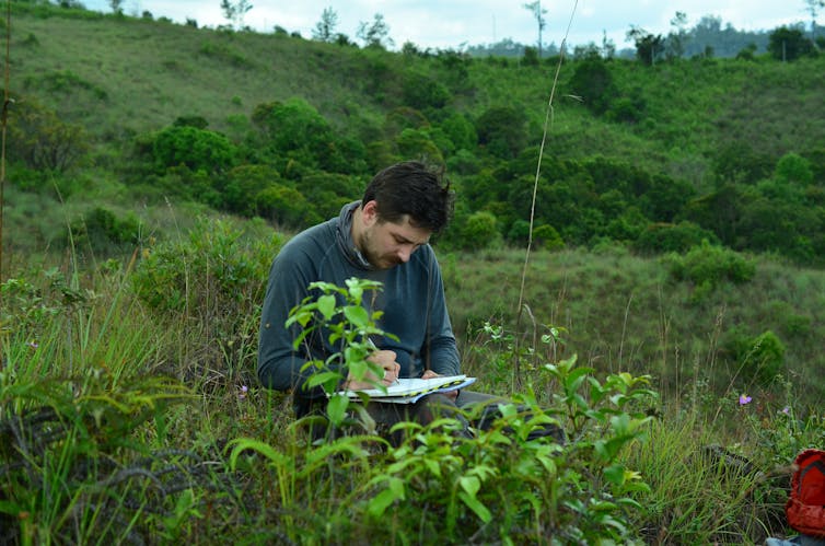 Image of the author investigating grass in Sri Lanka.