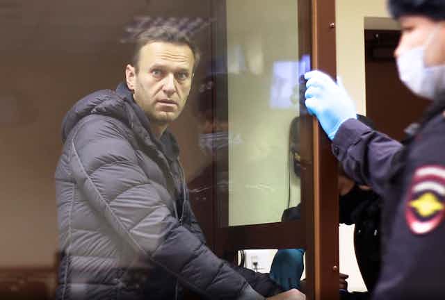 Alexei Navalny stands in a cage during a court hearing in February.