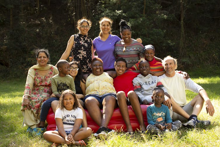 Group of diverse people happily posing for photo together.