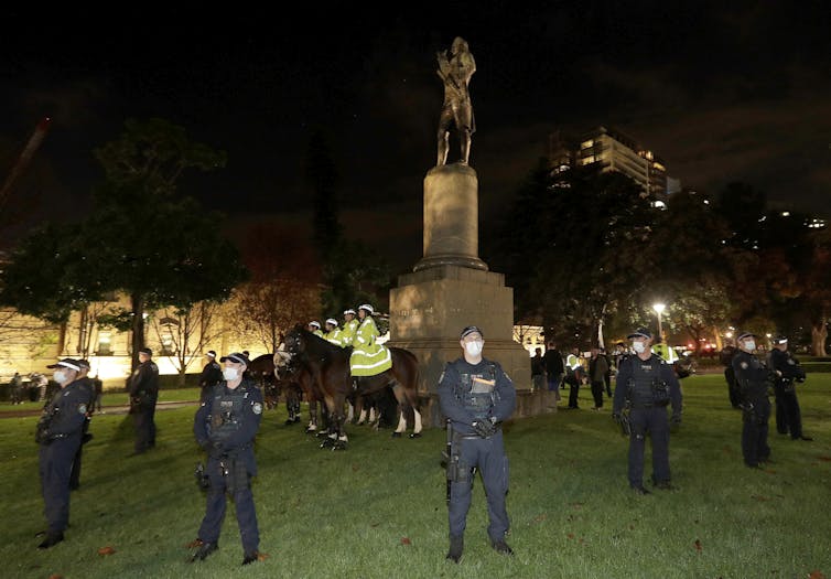 Police encircling the Cook statue in Sydney last year.